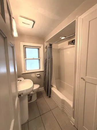 a bathroom with a granite countertop toilet sink and shower