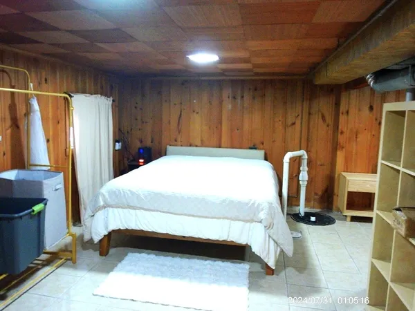 a bed sitting in a room next to a window