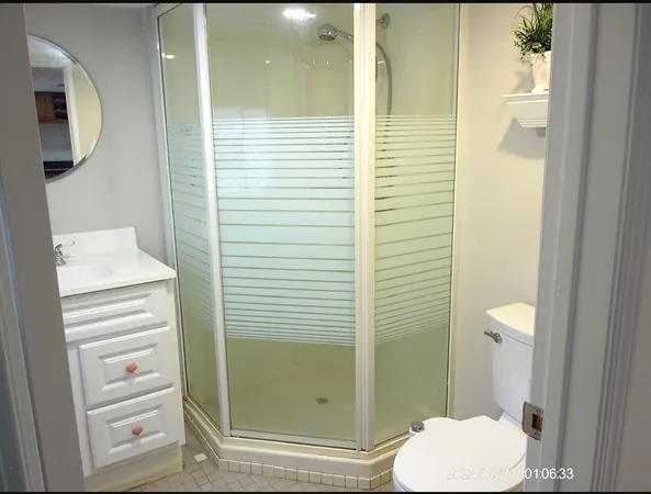 a bathroom with a toilet and a shower