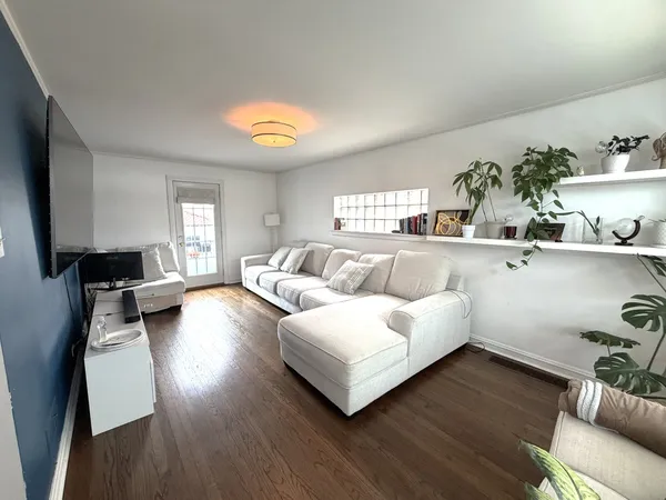 a living room with furniture and wooden floor