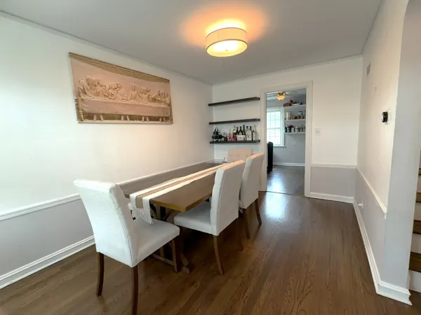 a dining room with furniture and wooden floor
