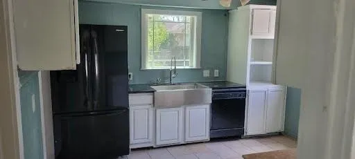 a kitchen with a refrigerator and a sink