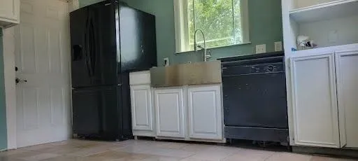 a stove top oven sitting inside of a kitchen