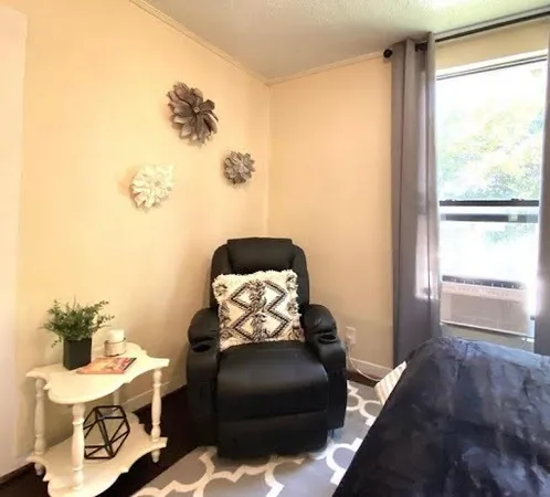 a bedroom with a large bed and a large window