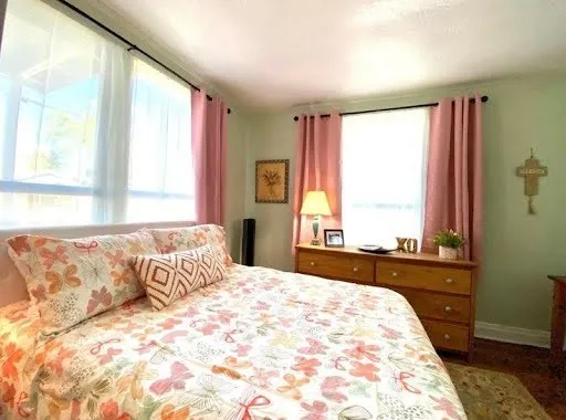a view of a bedroom with a bed and a window