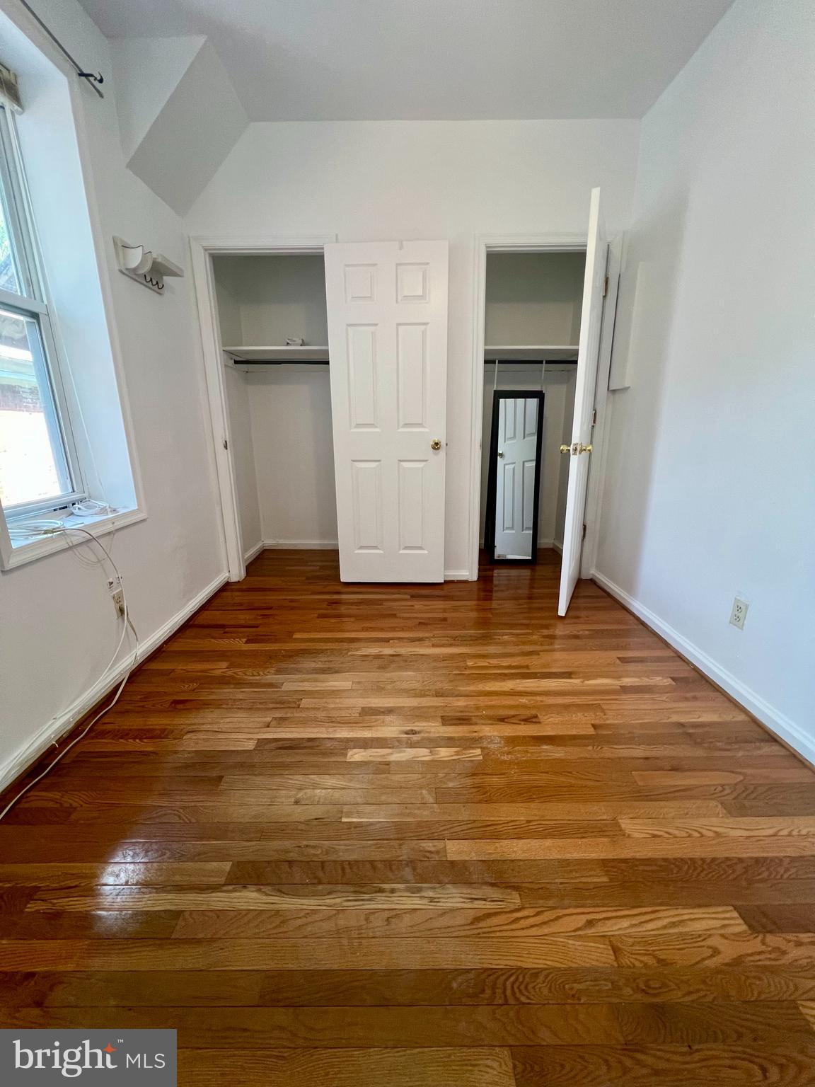 807 South St Bernard Street, Unit 3F Philadelphia, PA 19143 - Photo 11 of 17 a view of an empty room with window and wooden floor