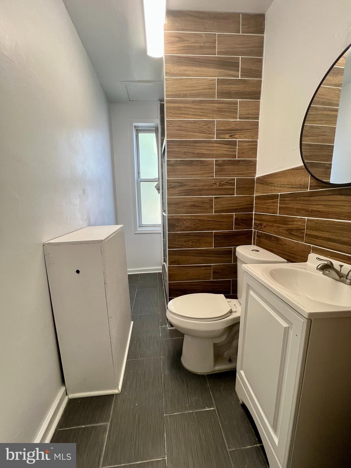 807 South St Bernard Street, Unit 3F Philadelphia, PA 19143 - Photo 12 of 17 a bathroom with a toilet and a mirror