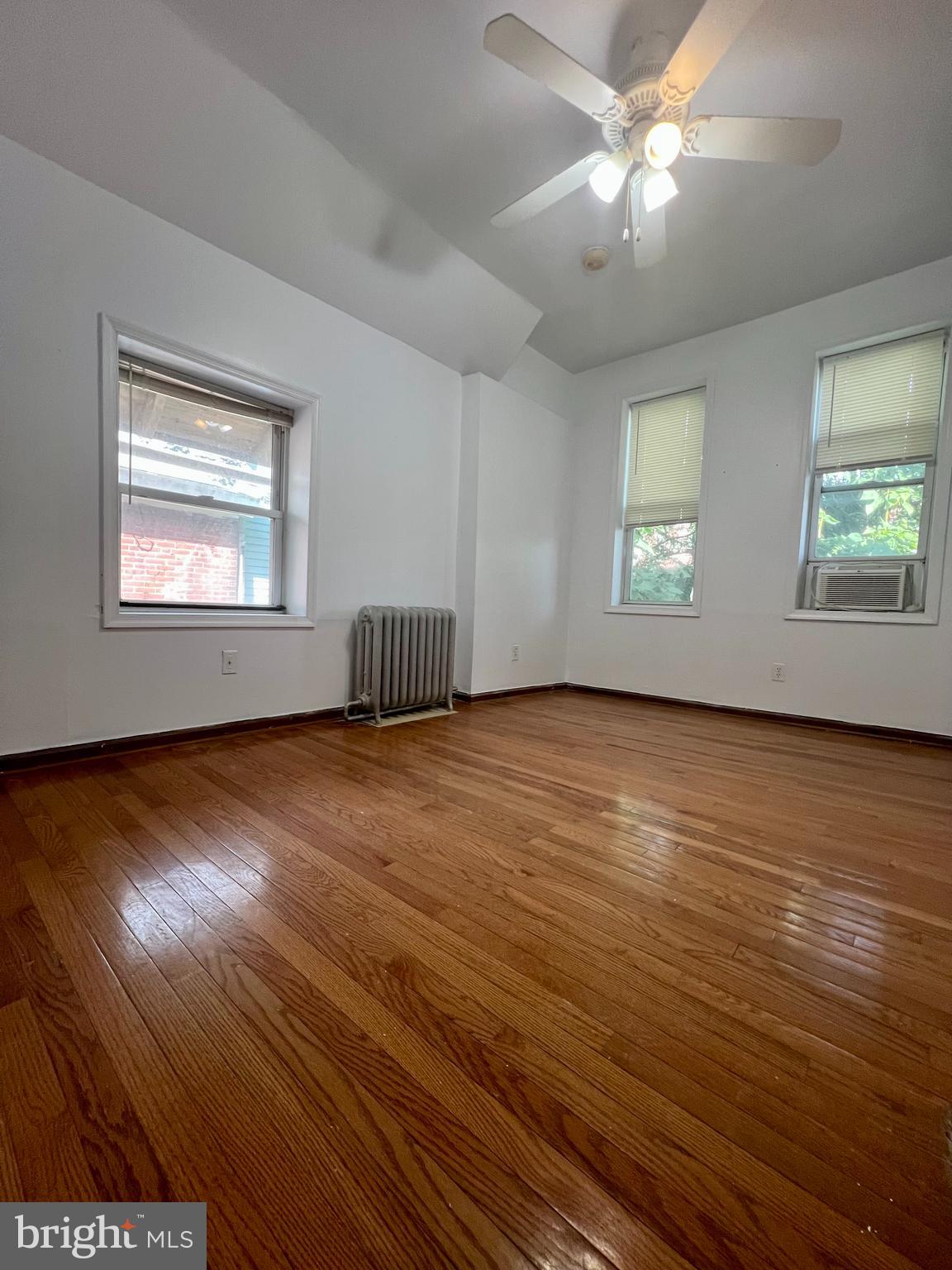 807 South St Bernard Street, Unit 3F Philadelphia, PA 19143 - Photo 14 of 17 a view of an empty room with wooden floor and a window