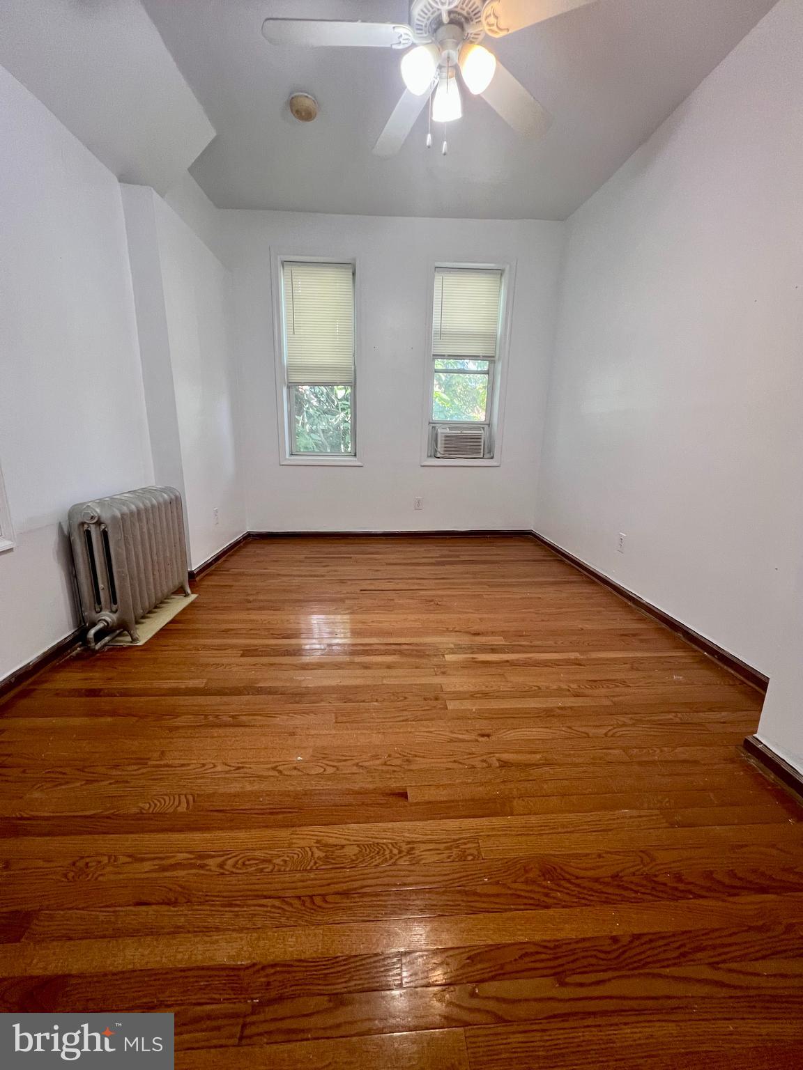 807 South St Bernard Street, Unit 3F Philadelphia, PA 19143 - Photo 15 of 17 wooden floor in an empty room with a window