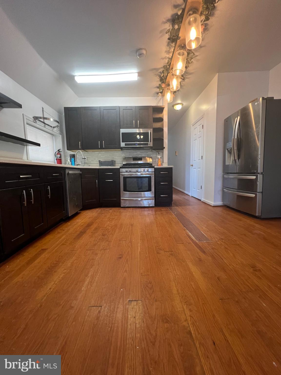 807 South St Bernard Street, Unit 3F Philadelphia, PA 19143 - Photo 8 of 17 a large kitchen with stainless steel appliances a large counter top
