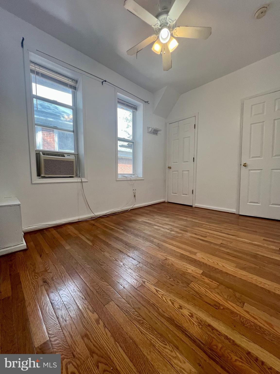 807 South St Bernard Street, Unit 3F Philadelphia, PA 19143 - Photo 10 of 17 an empty room with wooden floor and windows