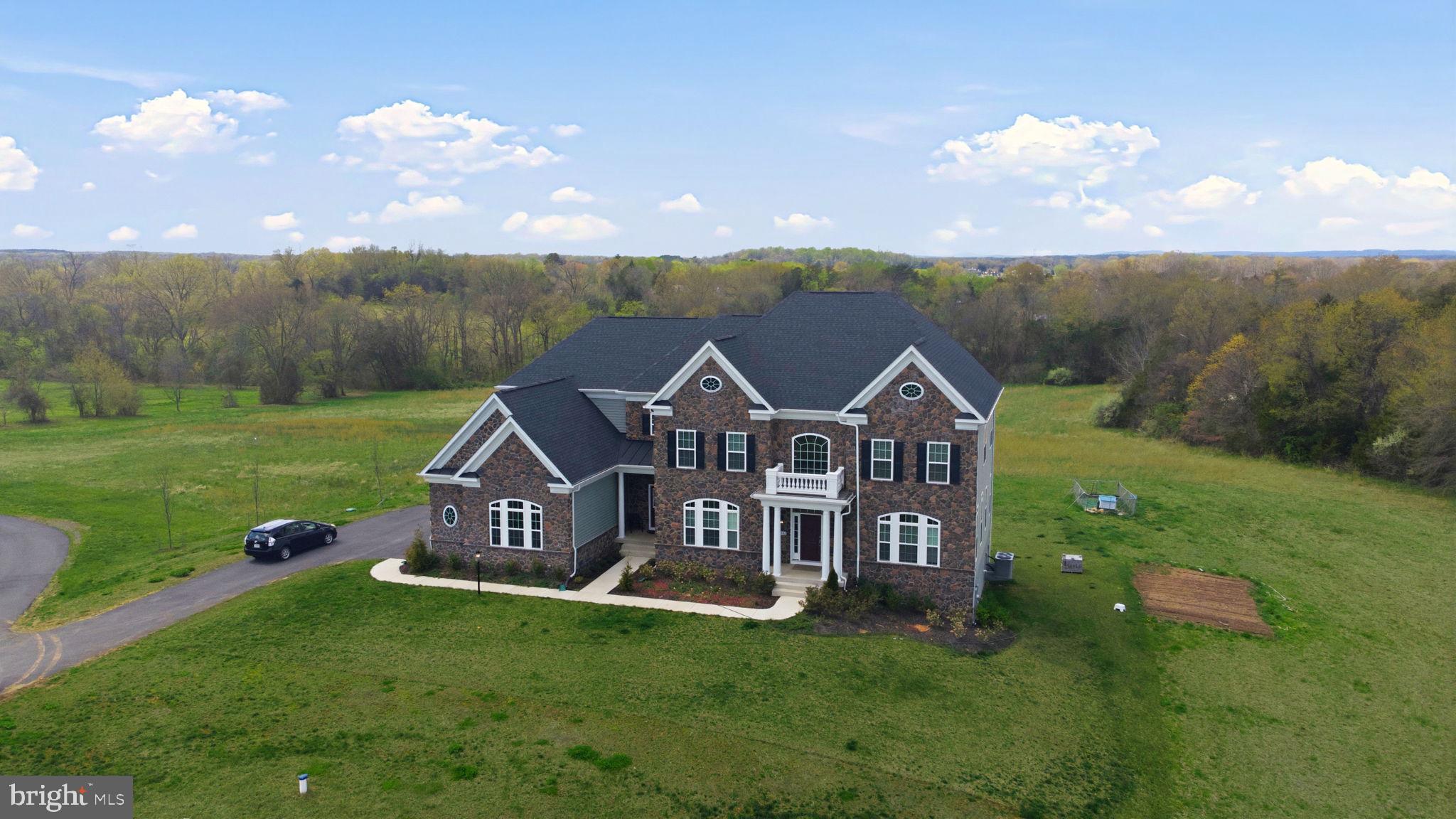11502 Aden Road Nokesville, VA 20181 - Photo 14 of 106 a view of a big house with a big yard and large tree