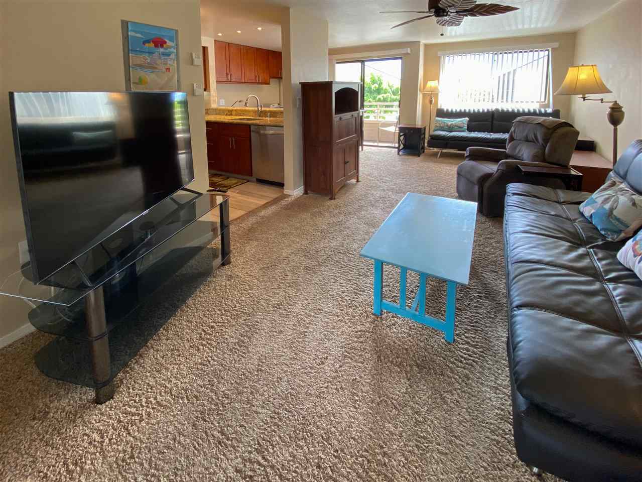 2747 South Kihei Road, Unit A201 Kihei, HI 96753 - Photo 15 of 29 a living room with furniture a flat screen tv and kitchen view