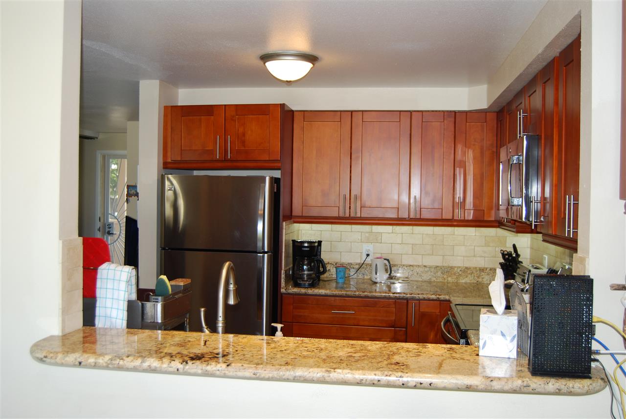 2747 South Kihei Road, Unit A201 Kihei, HI 96753 - Photo 4 of 29 a kitchen with a refrigerator and a sink