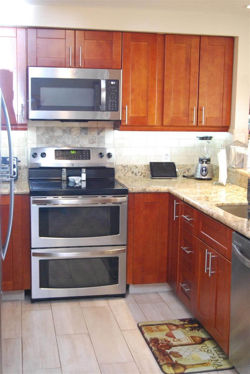 2747 South Kihei Road, Unit A201 Kihei, HI 96753 - Photo 6 of 29 a kitchen with a stove and a microwave