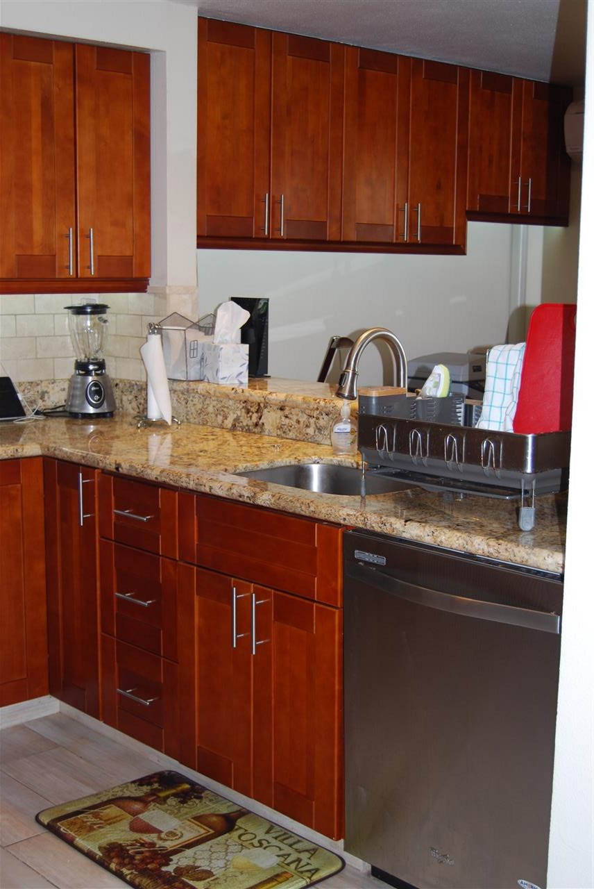 2747 South Kihei Road, Unit A201 Kihei, HI 96753 - Photo 7 of 29 a kitchen with stainless steel appliances granite countertop a sink dishwasher stove and cabinets