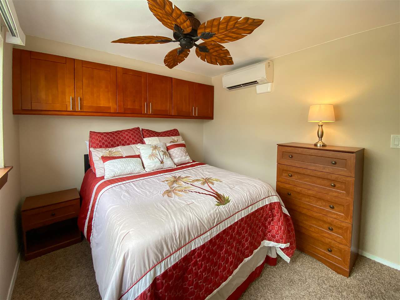 2747 South Kihei Road, Unit A201 Kihei, HI 96753 - Photo 9 of 29 a bedroom with a bed and a chandelier