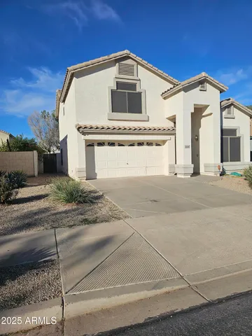 a front view of a house with a garage