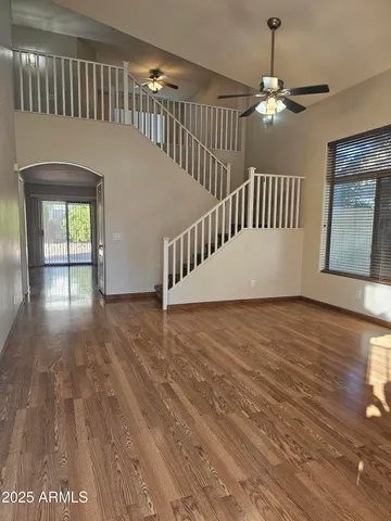 a view of staircase with railing and a chandelier