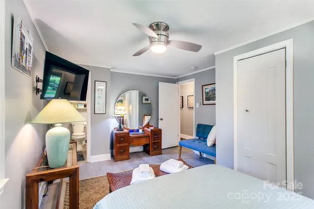 a living room with furniture a window and a chandelier