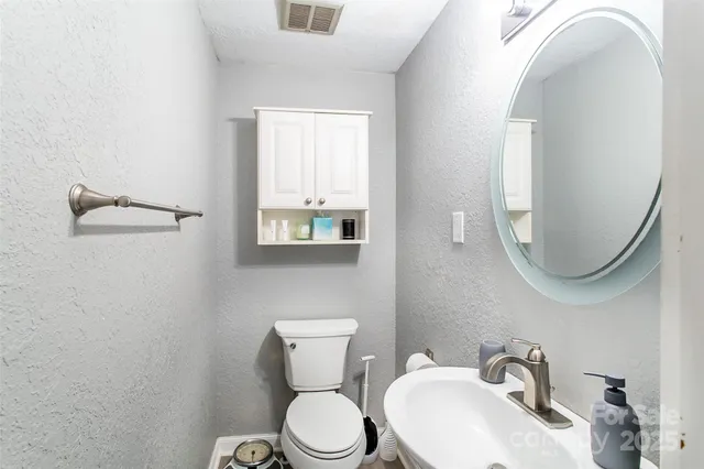 a white toilet sitting next to a bathroom sink