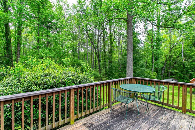 a view of a wooden bench and trees