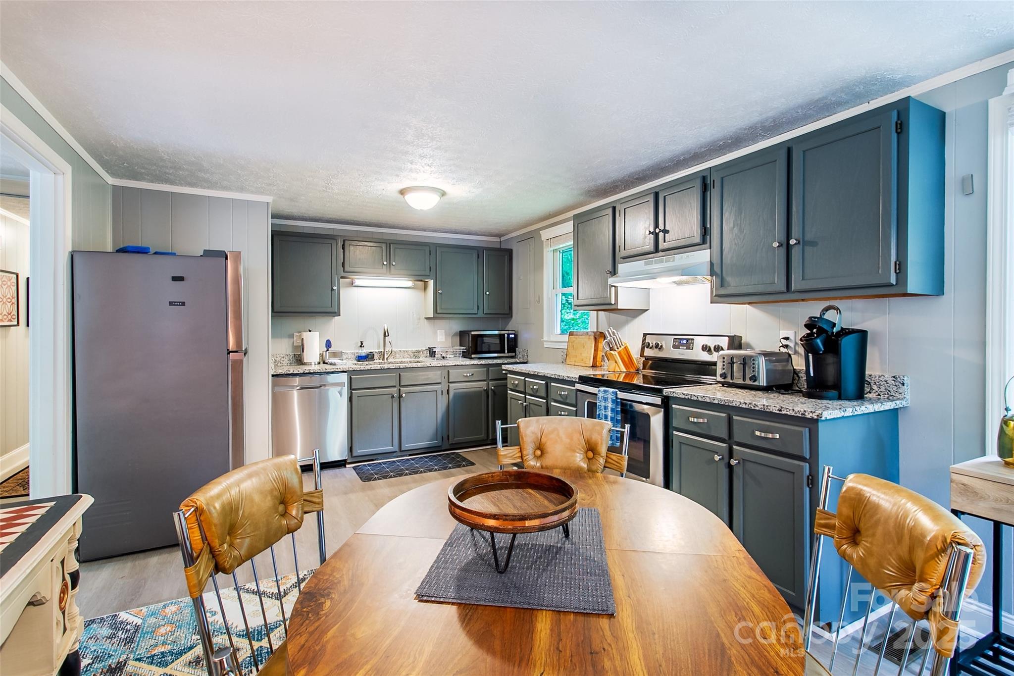 15 Pope Road Brevard, NC 28712 - Photo 8 of 29 a kitchen with granite countertop a sink cabinets and stainless steel appliances