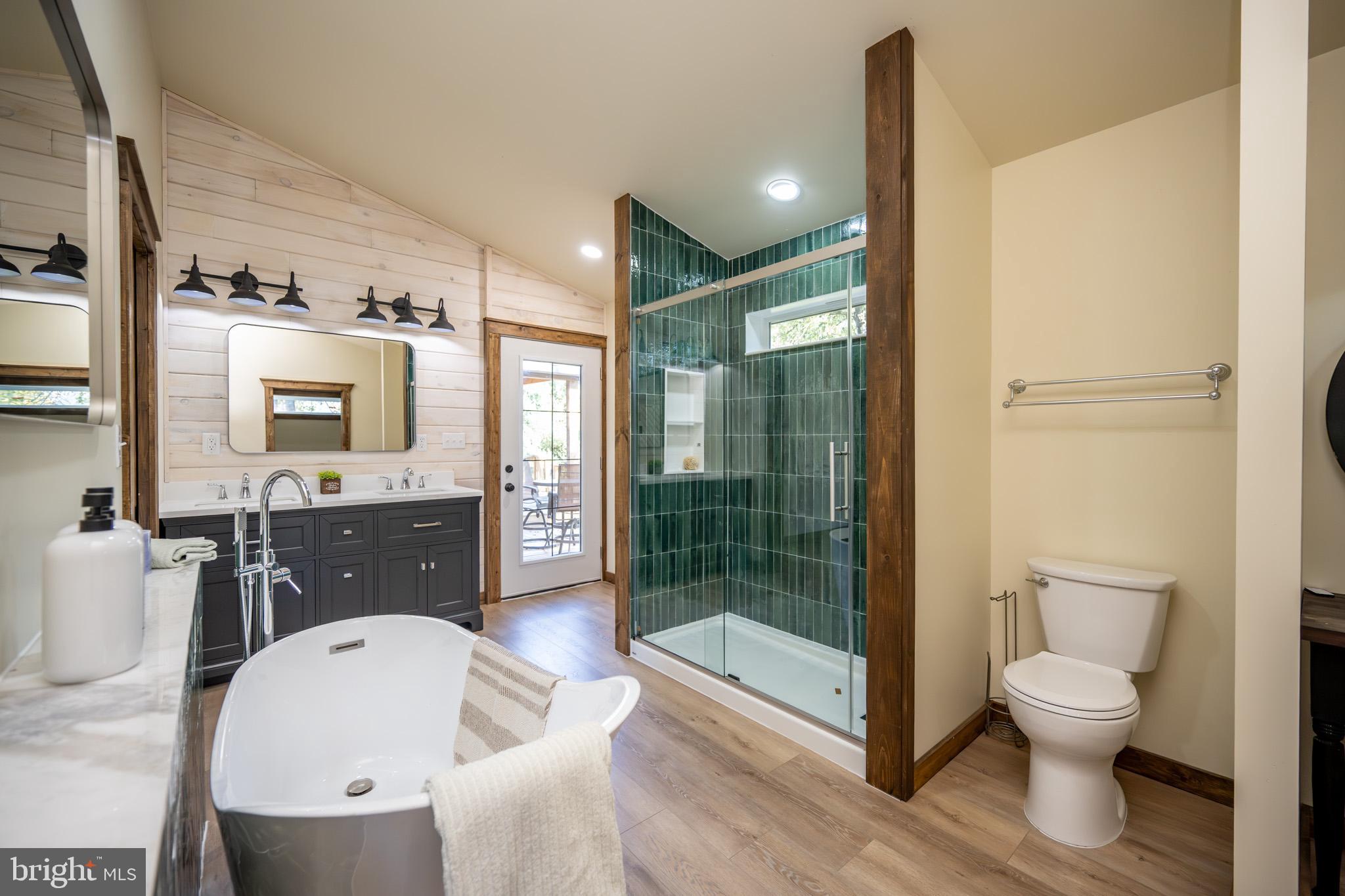 3456 Glendale Road Swanton, MD 21561 - Photo 47 of 93 a spacious bathroom with a toilet a sink and glass door