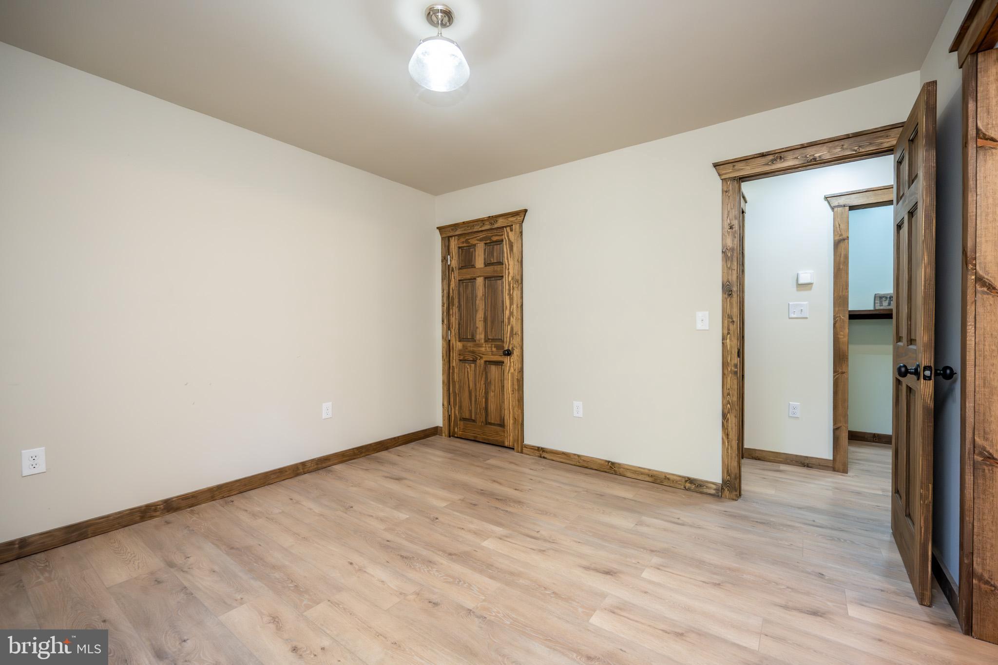 3456 Glendale Road Swanton, MD 21561 - Photo 57 of 93 an empty room with wooden floor and a window