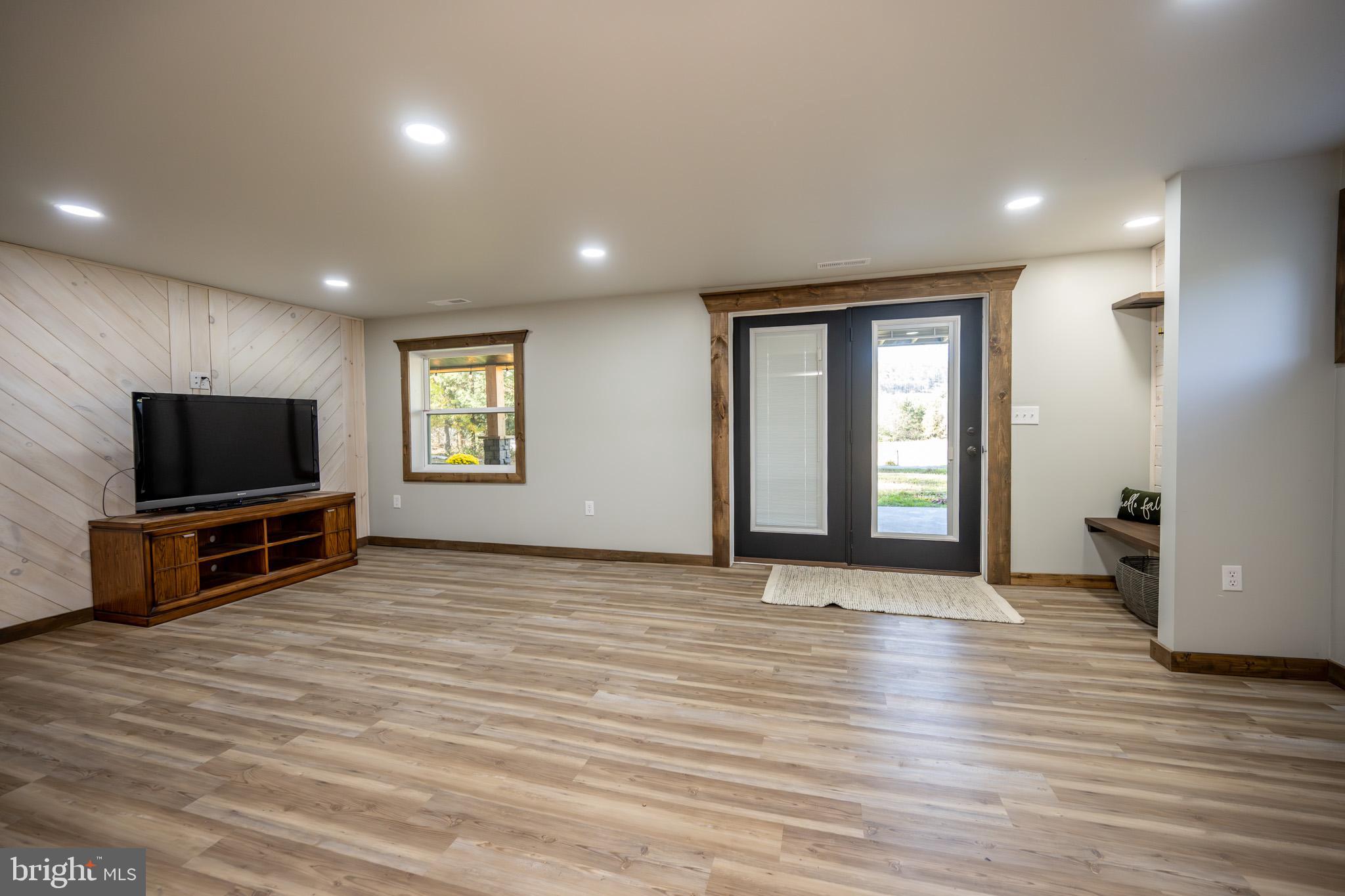 3456 Glendale Road Swanton, MD 21561 - Photo 63 of 93 a view of a livingroom with a flat screen tv wooden floor and a flat screen tv