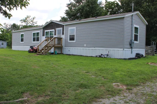 a view of a house with a backyard