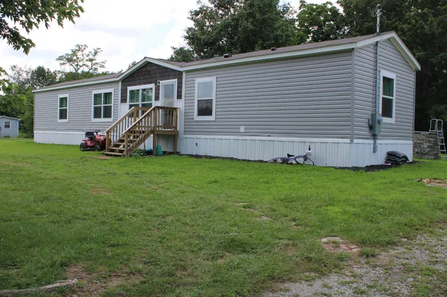 a view of a house with a backyard