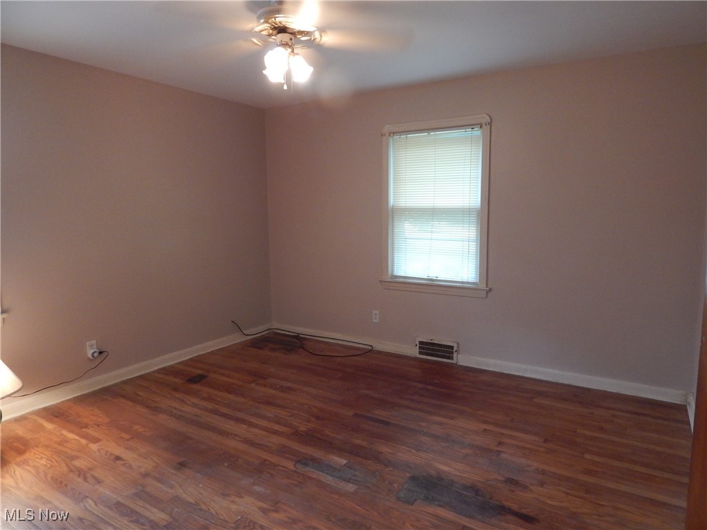 6990 Broadview Road Cleveland, OH 44134 - Photo 16 of 36 Bedroom #2 is extra-large on 1st floor & features 2 windows, ceiling fan & hardwood flooring.