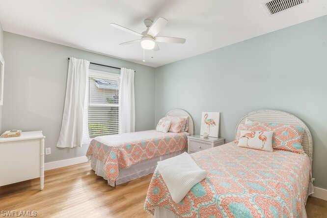 2876 West Crown Pointe Boulevard Naples, FL 34112 - Photo 15 of 36 Guest Bedroom two featuring all new LVT flooring, ensuite bath, and a ceiling fan.