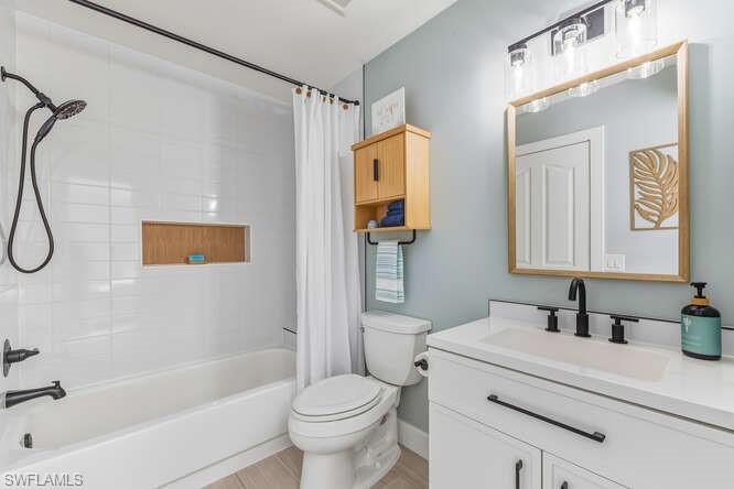 2876 West Crown Pointe Boulevard Naples, FL 34112 - Photo 17 of 36 Updated Guest Bathroom with new vanity and shower / bath combo, and tile flooring.