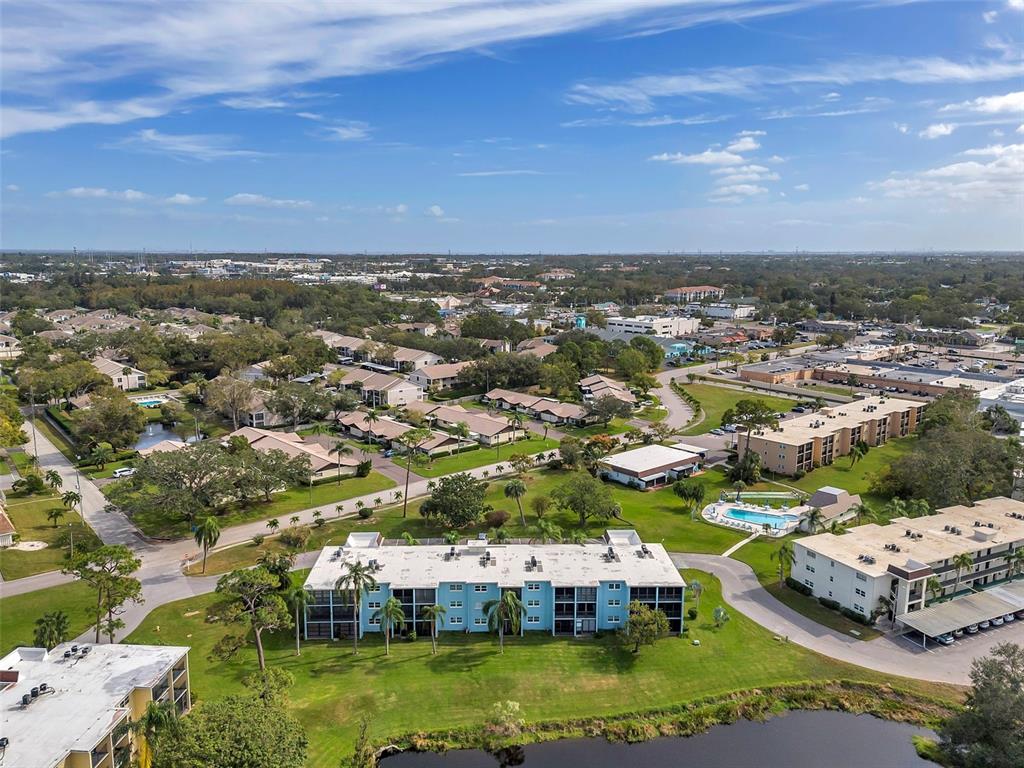 1430 Heather Ridge Boulevard, Unit 304 Dunedin, FL 34698 - Photo 32 of 36 an aerial view of residential houses with outdoor space