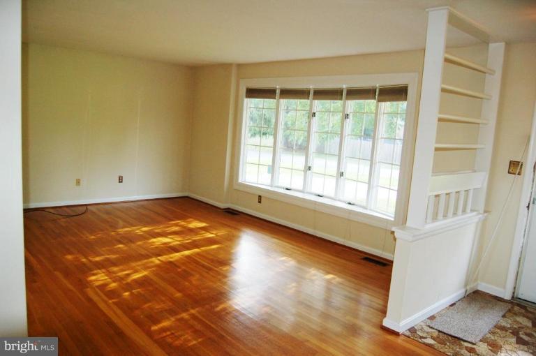 18809 Willow Grove Road Olney, MD 20832 - Photo 2 of 15 a view of an empty room with wooden floor and a window