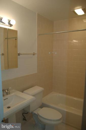 18809 Willow Grove Road Olney, MD 20832 - Photo 12 of 15 a bathroom with a sink a toilet and shower
