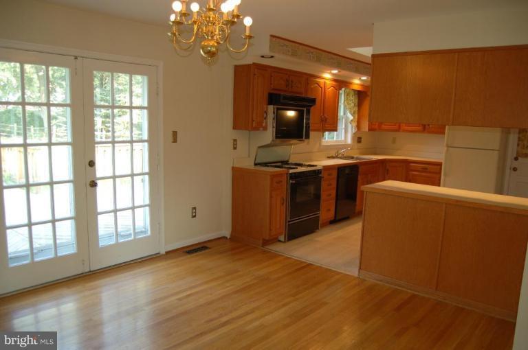 18809 Willow Grove Road Olney, MD 20832 - Photo 3 of 15 a kitchen with stainless steel appliances granite countertop a stove and a sink