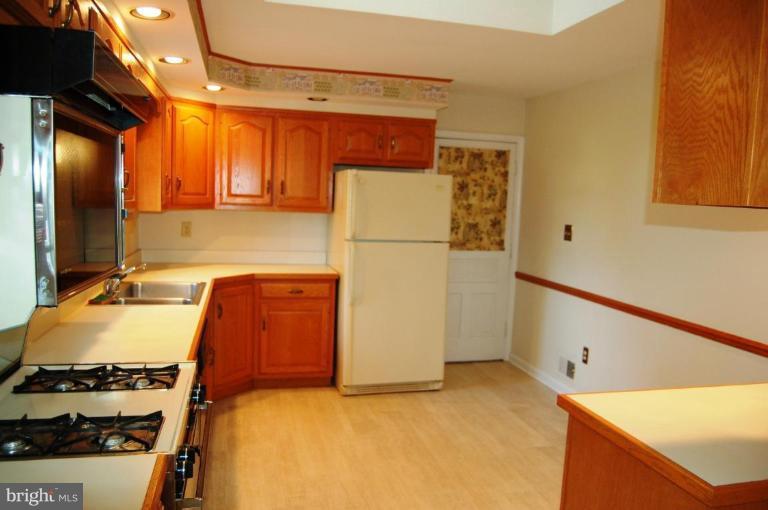 18809 Willow Grove Road Olney, MD 20832 - Photo 5 of 15 a kitchen with a refrigerator and a stove
