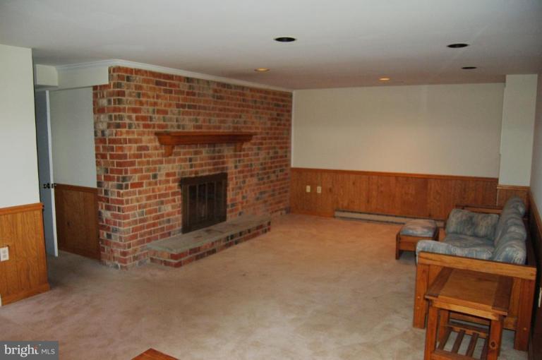 18809 Willow Grove Road Olney, MD 20832 - Photo 6 of 15 a view of an empty room with a fireplace