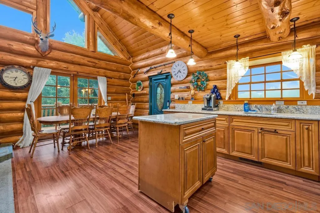 15469 Incapa Road Julian, CA 92036 - Photo 3 of 23 a kitchen with stainless steel appliances granite countertop wooden floors and white cabinets