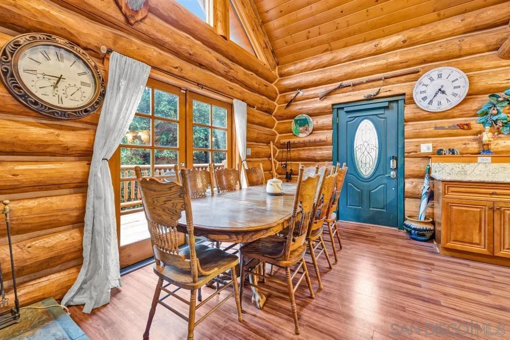 15469 Incapa Road Julian, CA 92036 - Photo 6 of 23 a dining room with furniture a clock and wooden floor