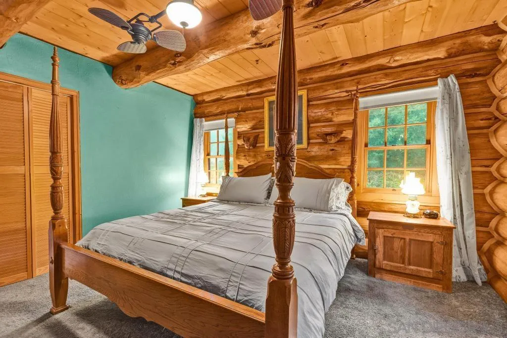 15469 Incapa Road Julian, CA 92036 - Photo 8 of 23 a bedroom with a bed and a chandelier