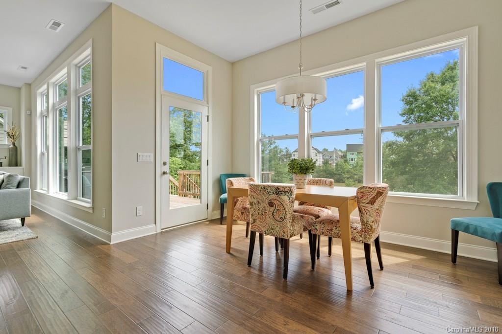 5354 Meadowcroft Way, Unit 56 Fort Mill, SC 29708 - Photo 14 of 36 a view of a dining room with furniture window and wooden floor