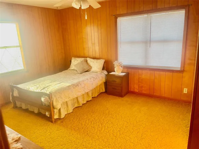 a bedroom with a bed and window