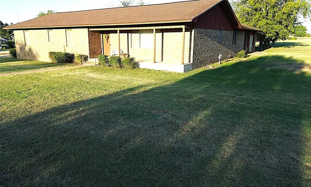 a view of an house with backyard and balcony