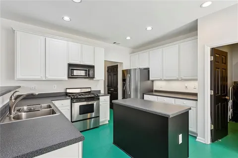 a kitchen with a sink a stove and refrigerator