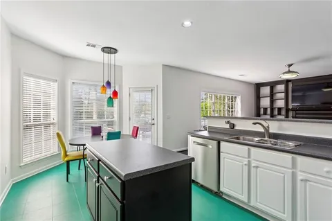 a kitchen that has a sink and a table in it