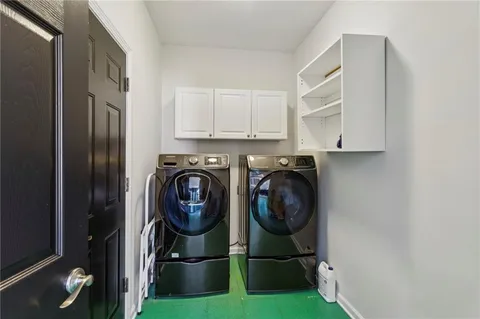 a utility room with sink dryer and washer